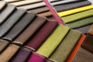 Photo of Samples of different fabrics as background, closeup