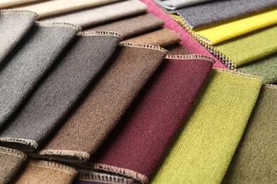 Photo of Samples of different fabrics as background, closeup