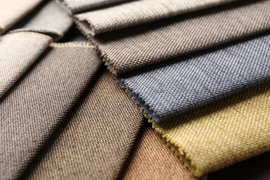 Photo of Samples of different fabrics as background, closeup