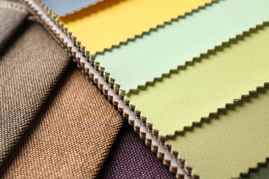 Photo of Samples of different fabrics as background, closeup