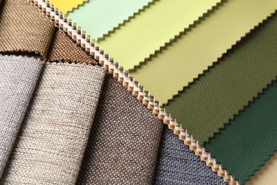 Photo of Samples of different fabrics as background, closeup