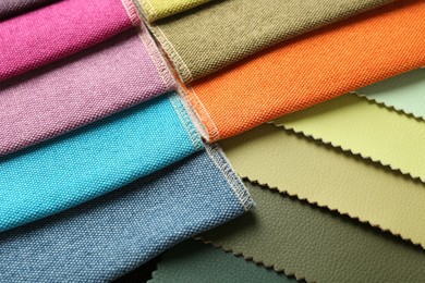 Photo of Samples of different fabrics as background, closeup