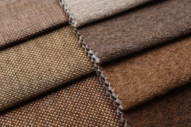 Photo of Samples of different fabrics as background, closeup