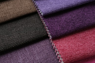 Photo of Samples of different fabrics as background, closeup