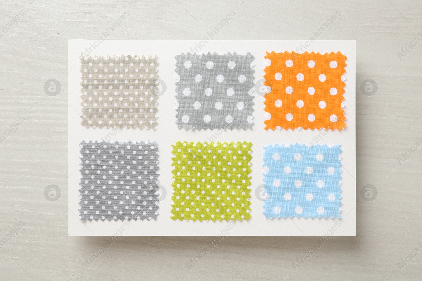 Samples of fabrics with polka dot pattern on light wooden table, top view Photo of Samples of fabrics with polka dot pattern on light wooden table, top view