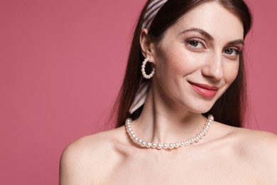 Photo of Fashionable portrait of beautiful woman in stylish outfit on pink background. Space for text