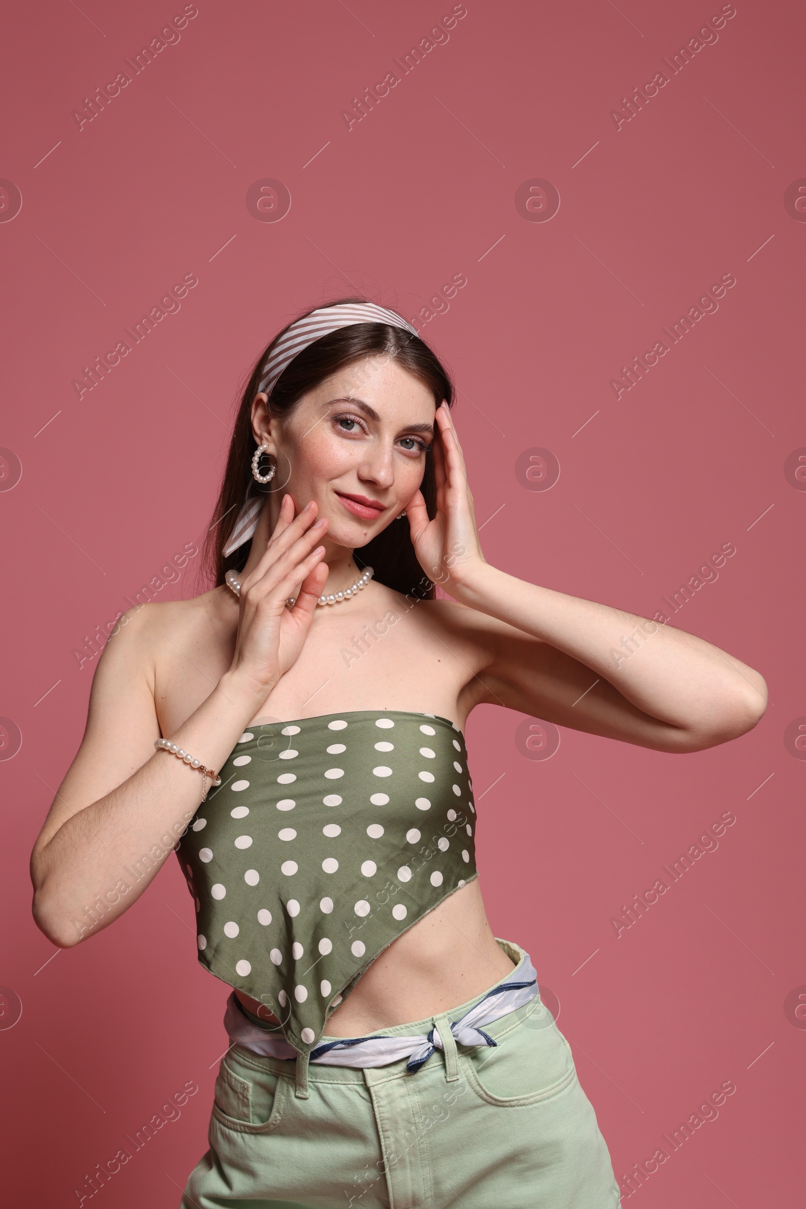 Fashionable portrait of beautiful woman in stylish outfit on pink background Photo of Fashionable portrait of beautiful woman in stylish outfit on pink background