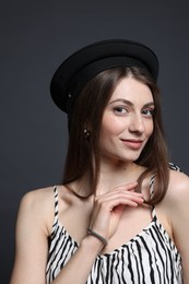 Photo of Fashionable portrait of beautiful woman in stylish outfit on grey background