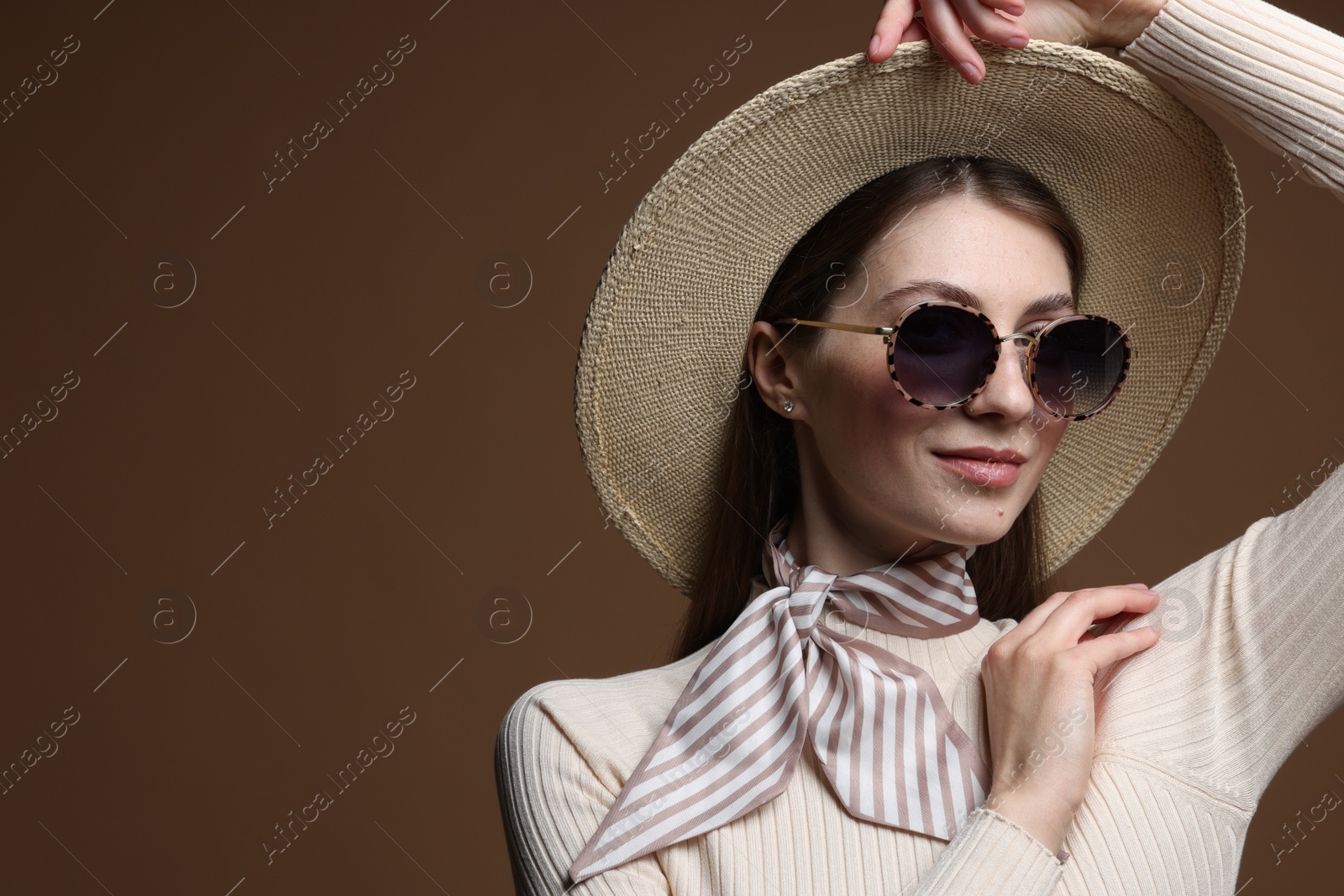 Fashionable portrait of beautiful woman in stylish outfit on brown background. Space for text Photo of Fashionable portrait of beautiful woman in stylish outfit on brown background. Space for text
