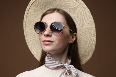 Photo of Fashionable portrait of beautiful woman in stylish outfit on brown background