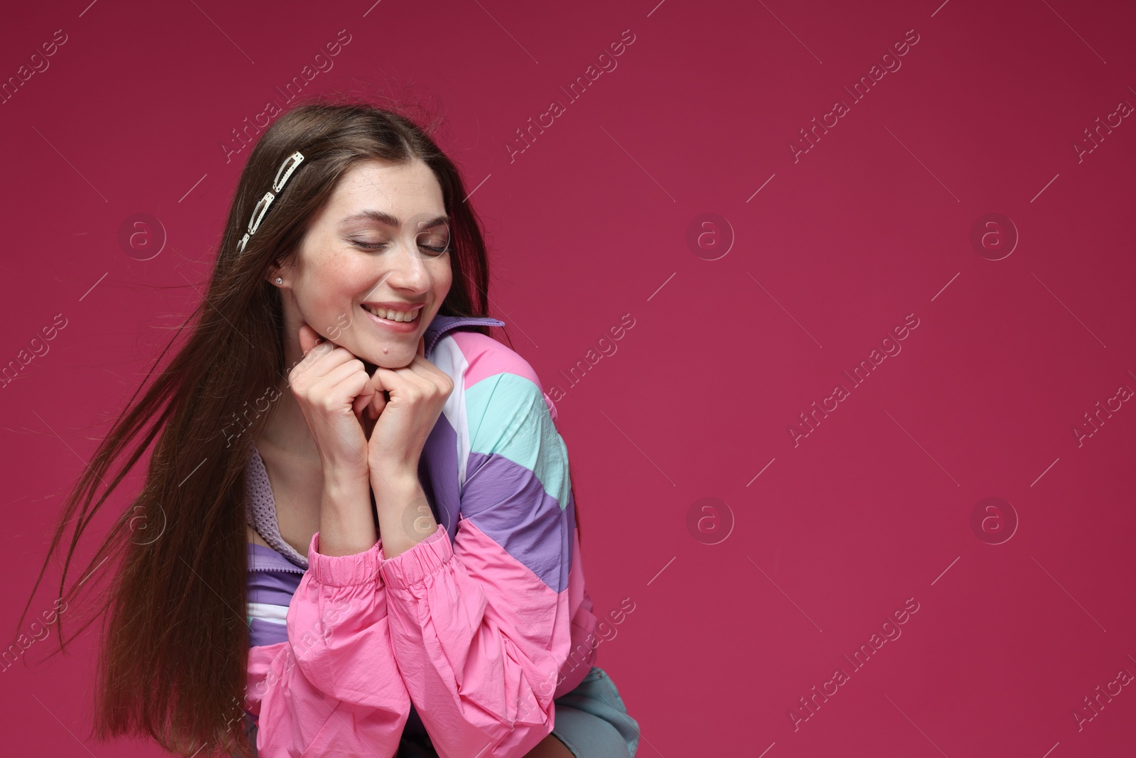 Fashionable portrait of beautiful woman in stylish outfit on crimson background. Space for text Photo of Fashionable portrait of beautiful woman in stylish outfit on crimson background. Space for text