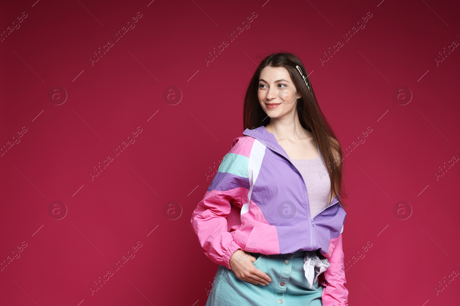 Fashionable portrait of beautiful woman in stylish outfit on crimson background. Space for text Photo of Fashionable portrait of beautiful woman in stylish outfit on crimson background. Space for text