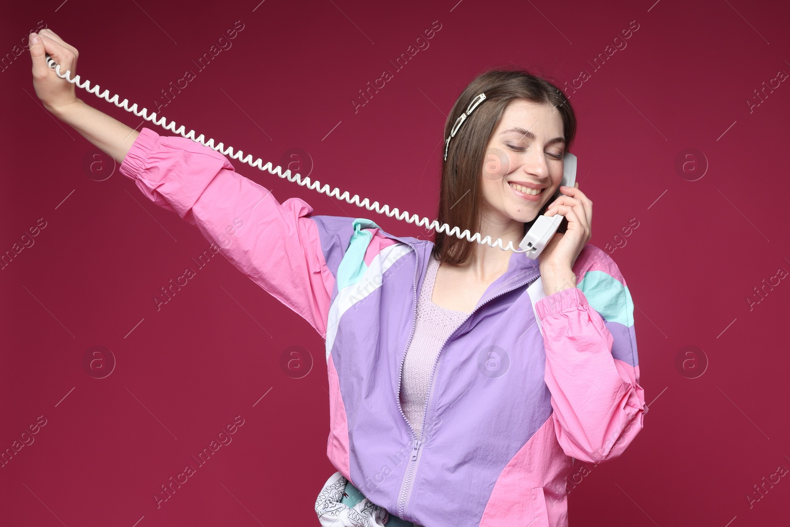 Fashionable portrait of beautiful woman in stylish outfit on crimson background Photo of Fashionable portrait of beautiful woman in stylish outfit on crimson background