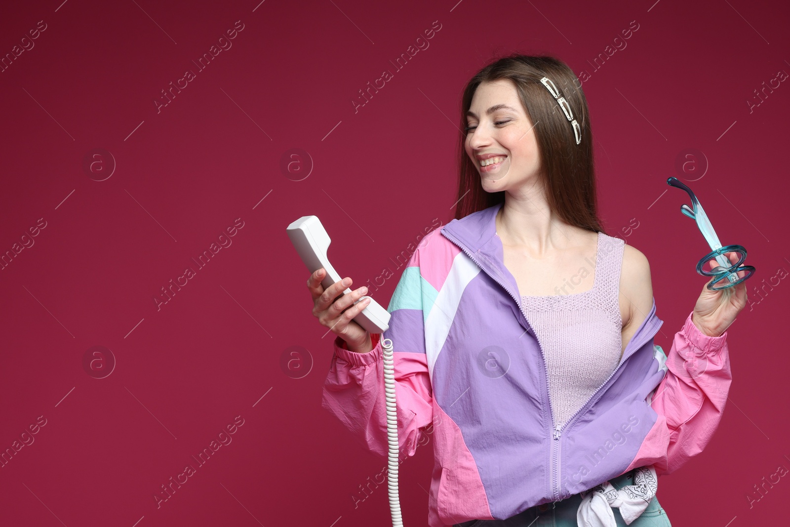 Fashionable portrait of beautiful woman in stylish outfit on crimson background. Space for text Photo of Fashionable portrait of beautiful woman in stylish outfit on crimson background. Space for text