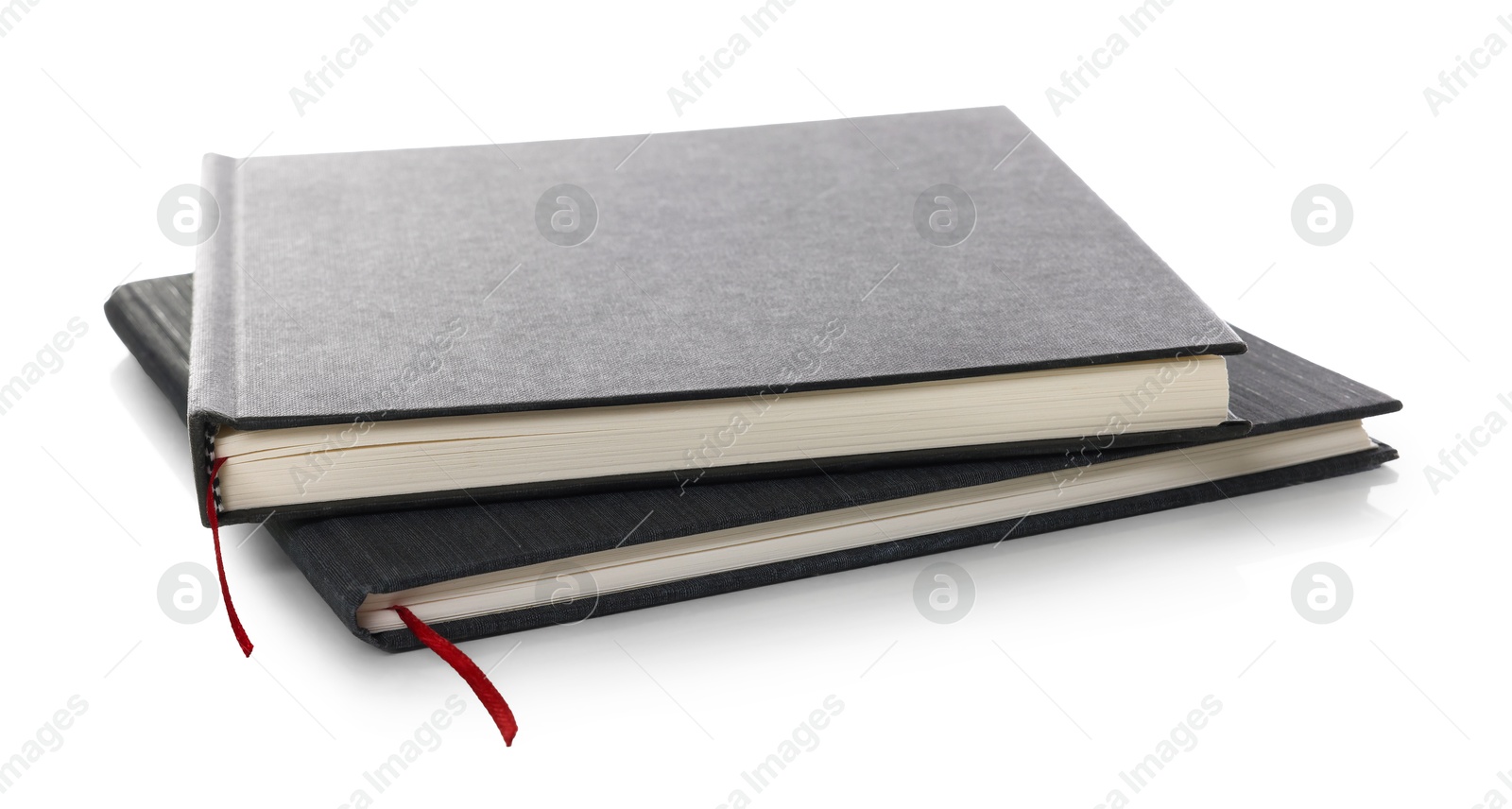 Two stylish hardcover notebooks isolated on white Photo of Two stylish hardcover notebooks isolated on white
