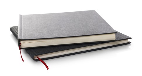 Photo of Two stylish hardcover notebooks isolated on white