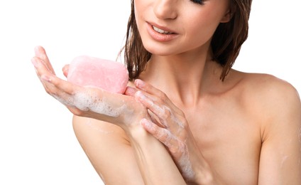 Photo of Woman with foaming soap bar on white background, closeup