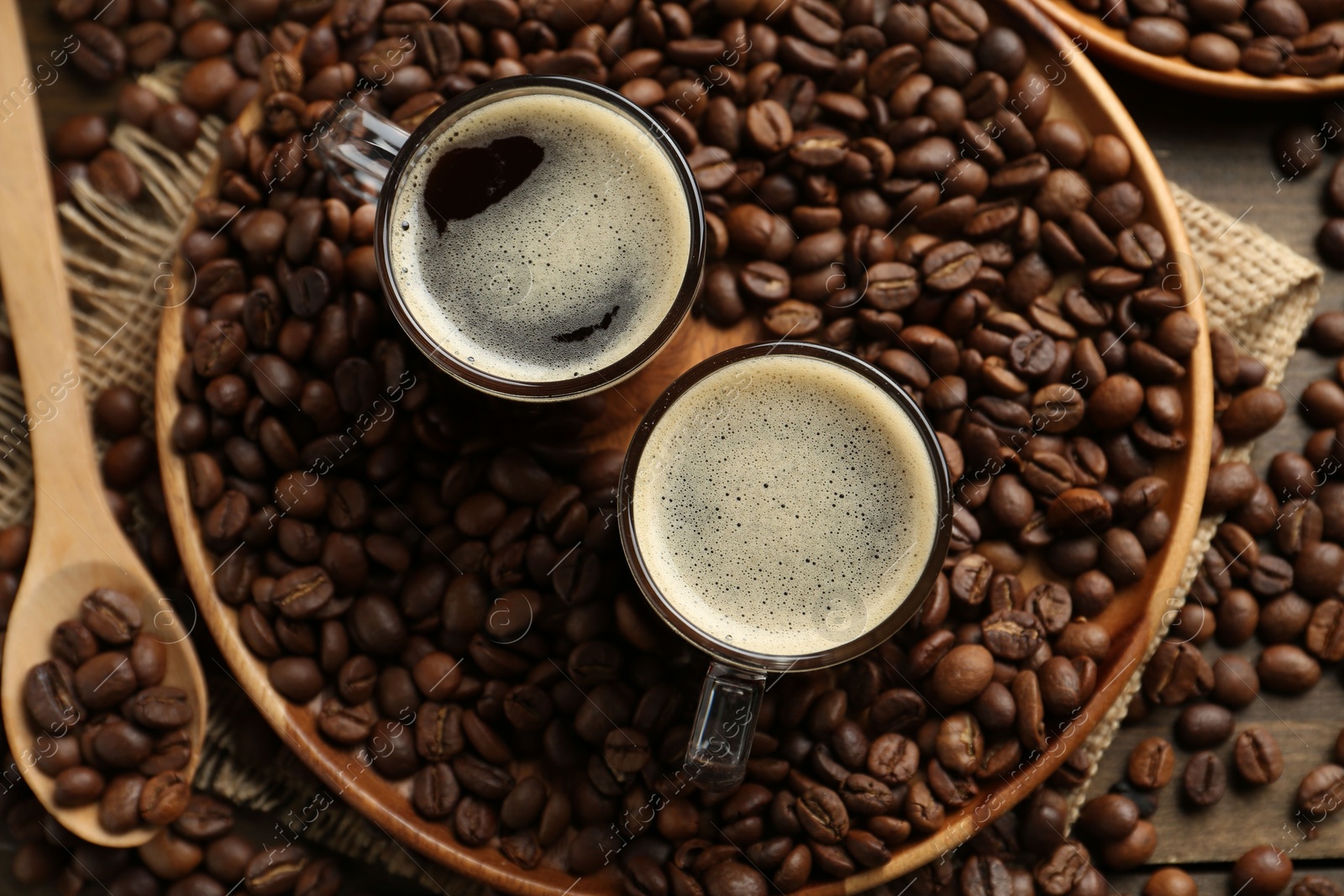 Aromatic coffee in cups and beans on table, flat lay Photo of Aromatic coffee in cups and beans on table, flat lay