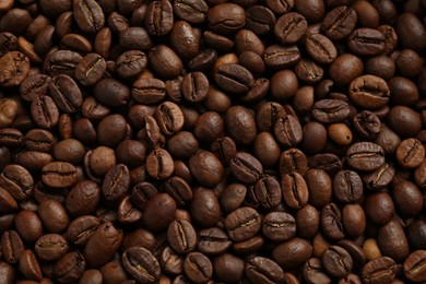 Photo of Aromatic coffee beans as background, top view