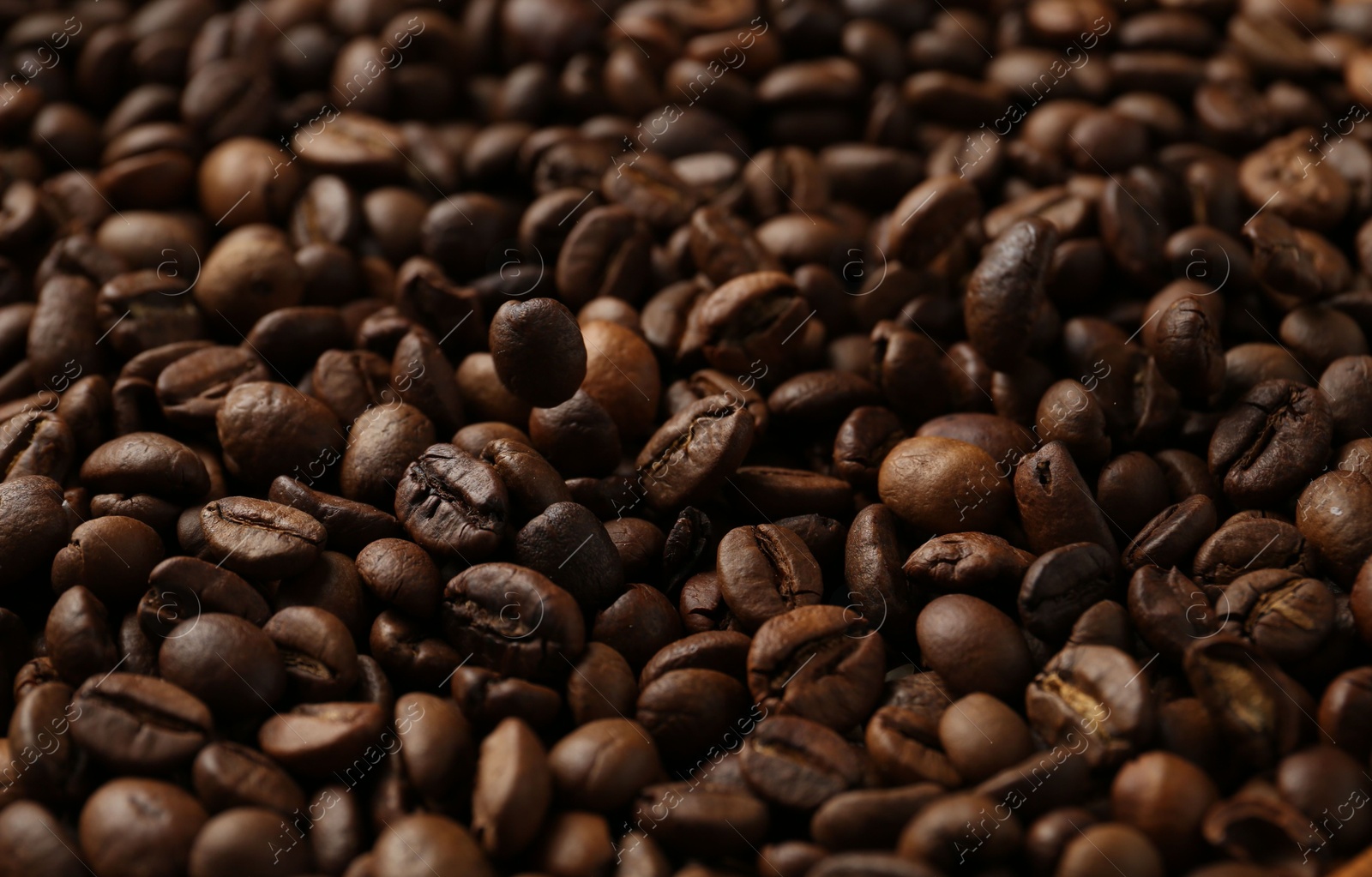 Aromatic coffee beans as background, closeup view Photo of Aromatic coffee beans as background, closeup view