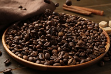 Photo of Pouring coffee beans onto plate at table, closeup