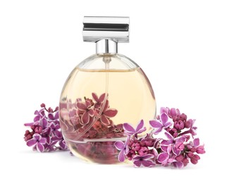 Photo of Bottle of luxury perfume and lilac flowers isolated on white