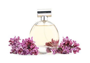 Photo of Bottle of luxury perfume and lilac flowers isolated on white