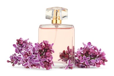 Photo of Bottle of luxury perfume and lilac flowers isolated on white