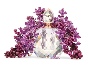 Photo of Bottle of luxury perfume and lilac flowers isolated on white