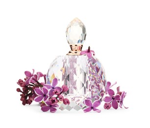Photo of Bottle of luxury perfume and lilac flowers isolated on white
