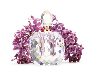 Photo of Bottle of luxury perfume and lilac flowers isolated on white