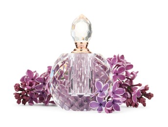 Photo of Bottle of luxury perfume and lilac flowers isolated on white