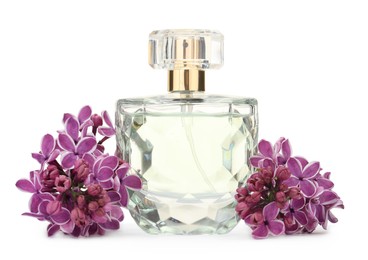 Photo of Bottle of luxury perfume and lilac flowers isolated on white