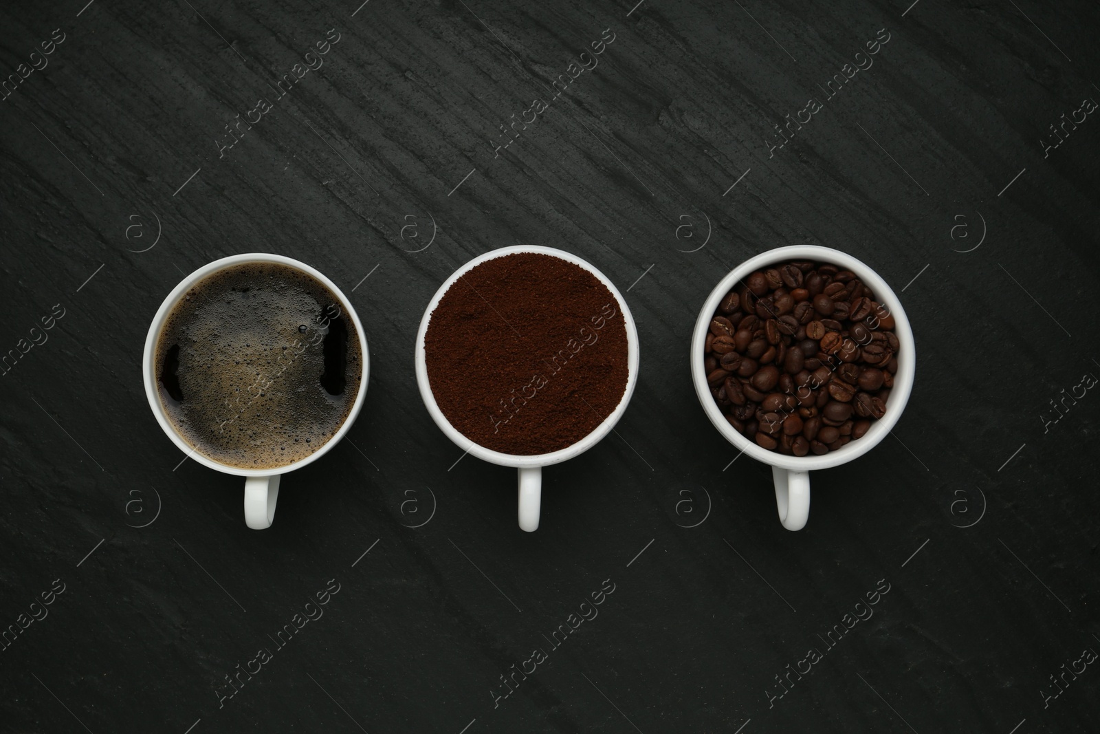 Aromatic ground coffee, beans and hot drink on black table, flat lay Photo of Aromatic ground coffee, beans and hot drink on black table, flat lay