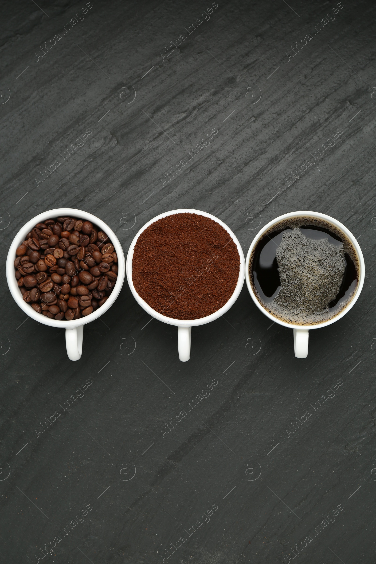 Aromatic ground coffee, beans and hot drink on black table, flat lay Photo of Aromatic ground coffee, beans and hot drink on black table, flat lay