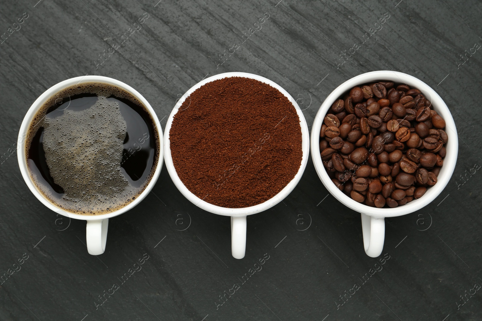 Aromatic ground coffee, beans and hot drink on black table, flat lay Photo of Aromatic ground coffee, beans and hot drink on black table, flat lay