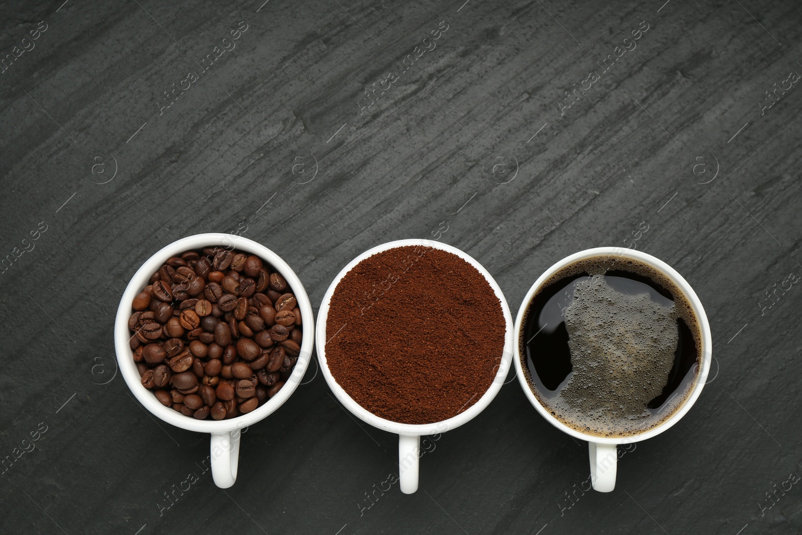 Aromatic ground coffee, beans and hot drink on black table, flat lay. Space for text Photo of Aromatic ground coffee, beans and hot drink on black table, flat lay. Space for text