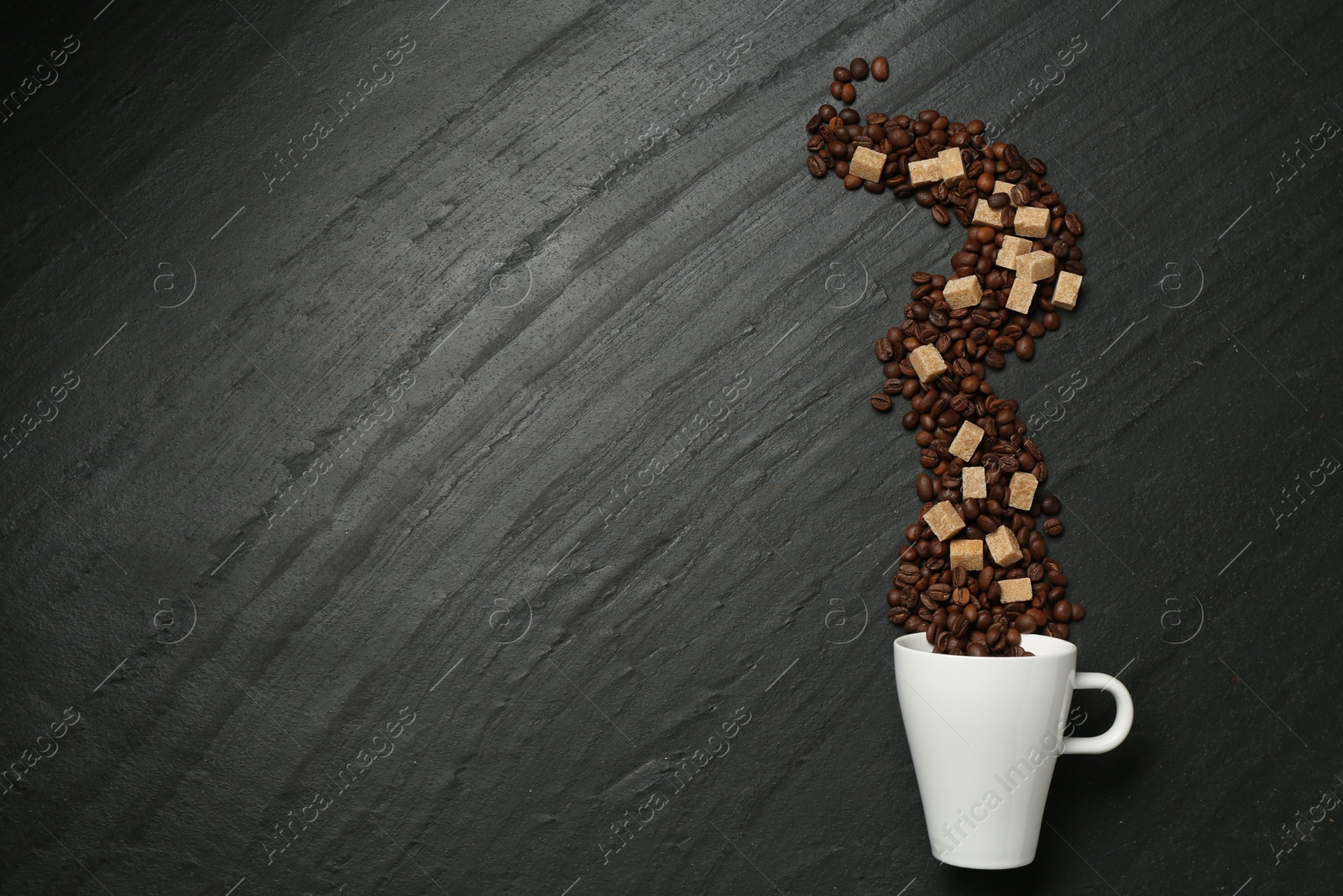 Aromatic coffee beans, brown sugar and cup on black table, flat lay. Space for text Photo of Aromatic coffee beans, brown sugar and cup on black table, flat lay. Space for text