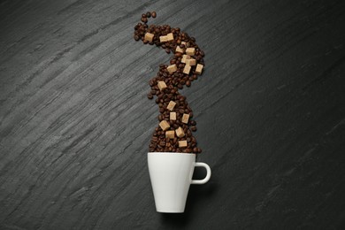 Photo of Aromatic coffee beans, brown sugar and cup on black table, flat lay