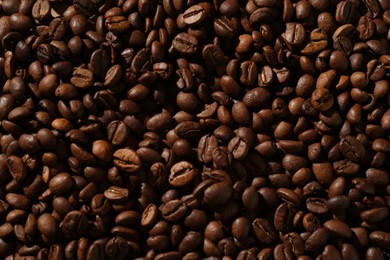 Photo of Aromatic coffee beans as background, top view