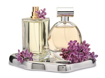 Photo of Luxury perfumes and beautiful lilac flowers isolated on white