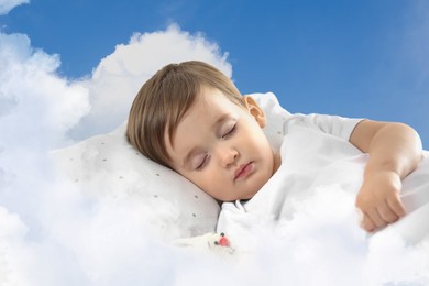 Image of Cute little baby sleeping on fluffy cloud in blue sky. Bedtime, sweet dream