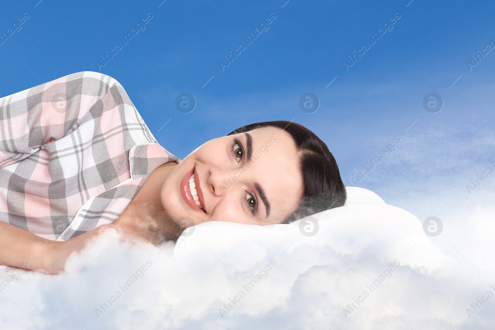 Young woman lying on fluffy cloud in blue sky. Bedtime Image of Young woman lying on fluffy cloud in blue sky. Bedtime