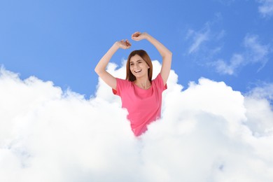 Image of Woman sitting on fluffy cloud in blue sky. Bedtime