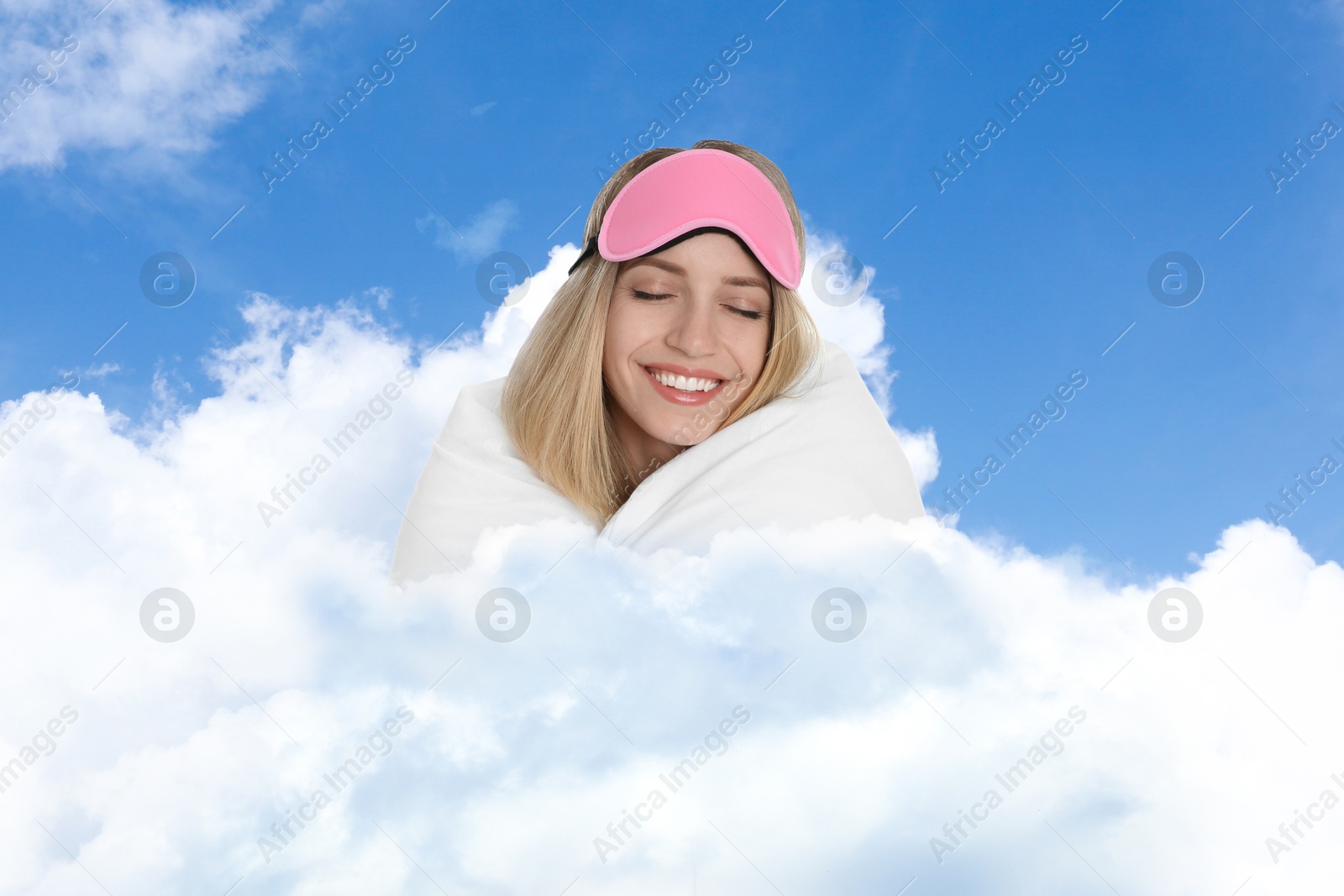 Young woman with sleep mask and blanket on fluffy cloud in blue sky. Bedtime Image of Young woman with sleep mask and blanket on fluffy cloud in blue sky. Bedtime