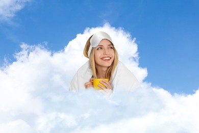 Image of Young woman with sleep mask and cup of drink in fluffy cloud in blue sky. Bedtime