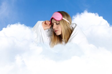 Image of Young woman with sleep mask and blanket on fluffy cloud in blue sky. Bedtime