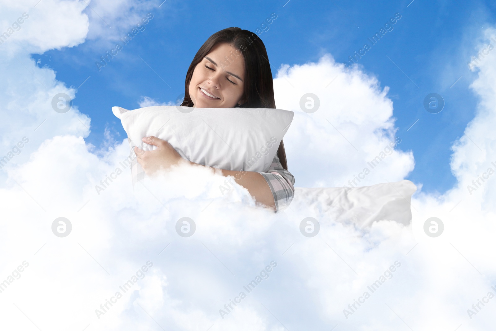 Young woman with pillow sitting on fluffy cloud in blue sky. Bedtime Image of Young woman with pillow sitting on fluffy cloud in blue sky. Bedtime