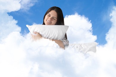 Image of Young woman with pillow sitting on fluffy cloud in blue sky. Bedtime