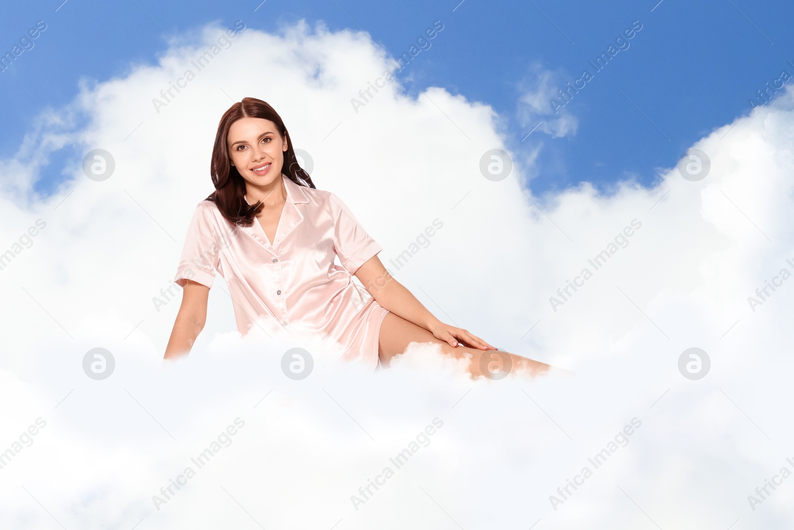 Young woman wearing pajamas on fluffy cloud in blue sky. Bedtime Image of Young woman wearing pajamas on fluffy cloud in blue sky. Bedtime